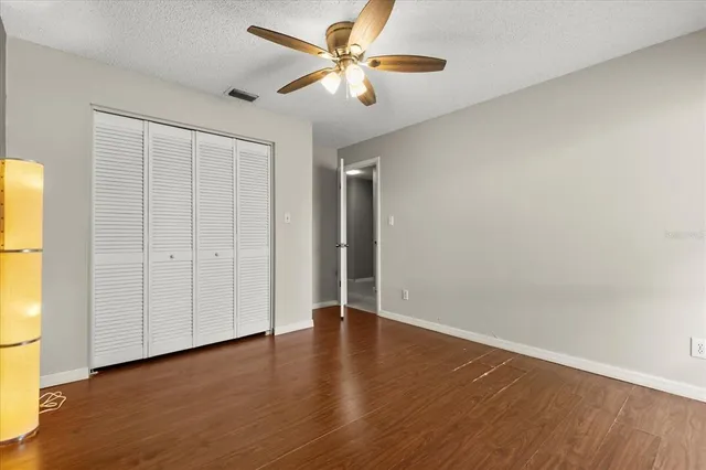 an empty room with wooden floor and a window