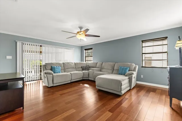 a living room with furniture and a wooden floor