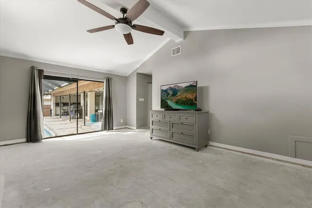 a view of livingroom with furniture ceiling fan and window
