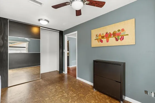 a view of a hallway with front door and wooden floor