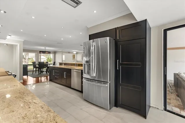a kitchen with stainless steel appliances a refrigerator and a stove top oven