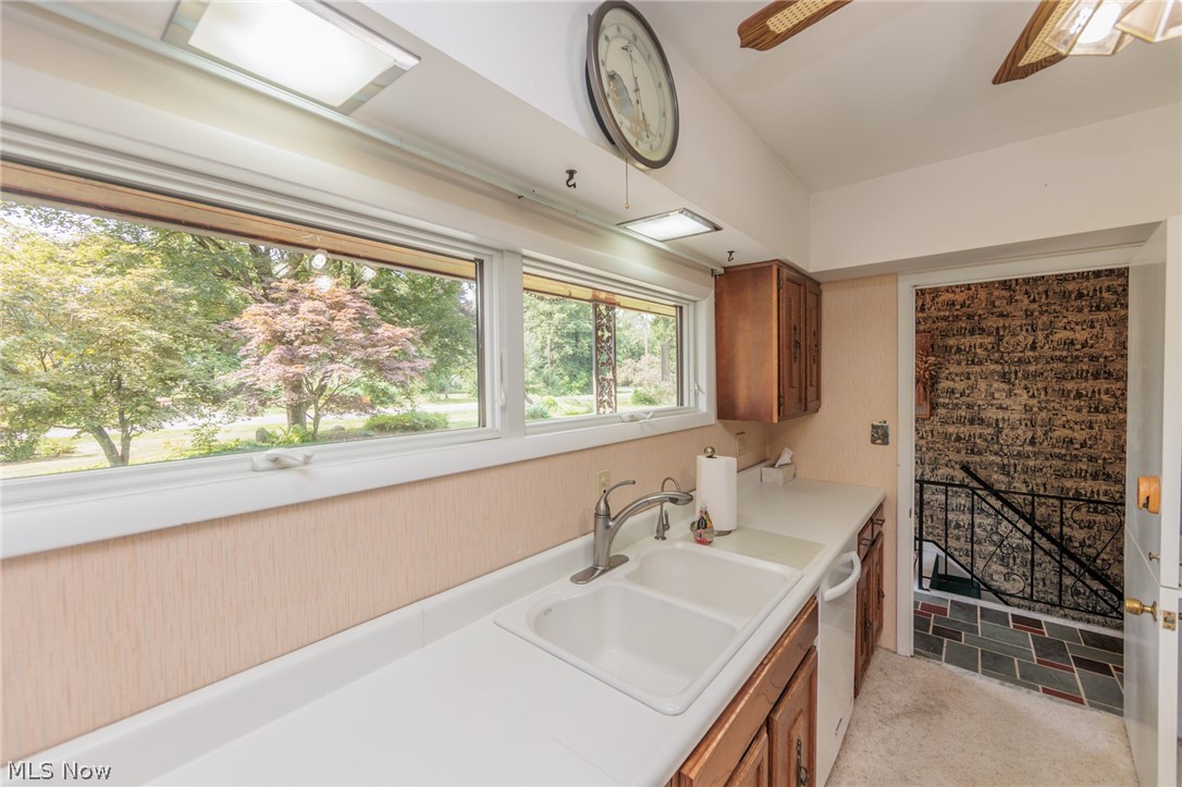 425 Bittersweet Road Akron, OH 44333 - Photo 27 of 50 Kitchen with light tile patterned floors, vaulted ceiling, dishwasher, and sink