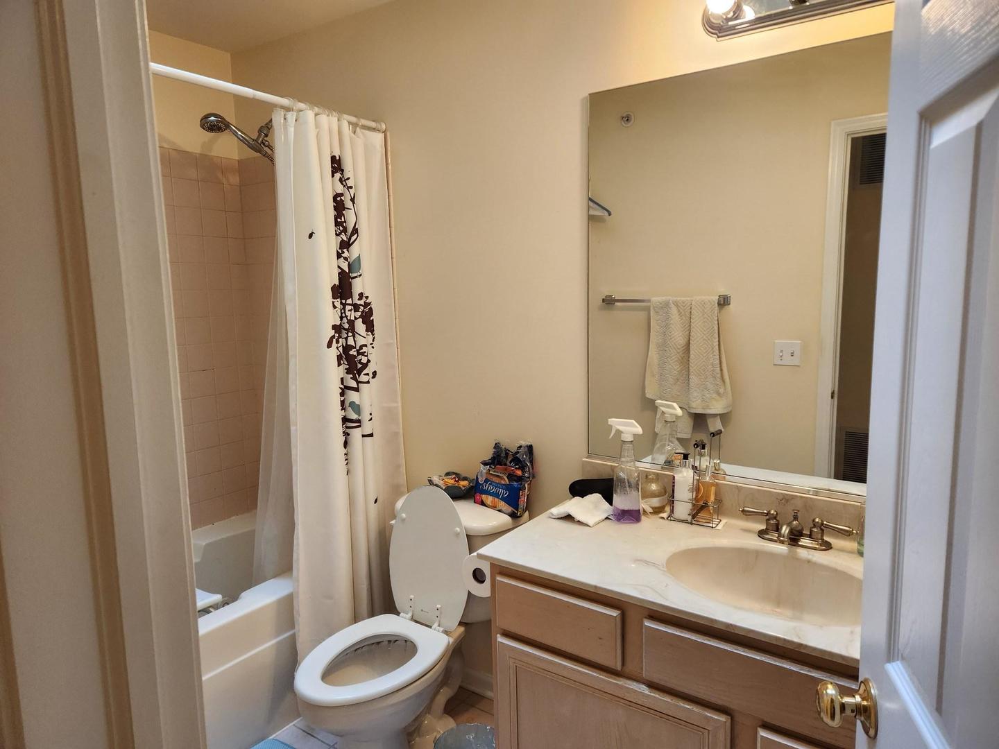 670 Mill Circle, Unit 305 Wheeling, IL 60090 - Photo 12 of 16 a bathroom with a sink toilet and shower