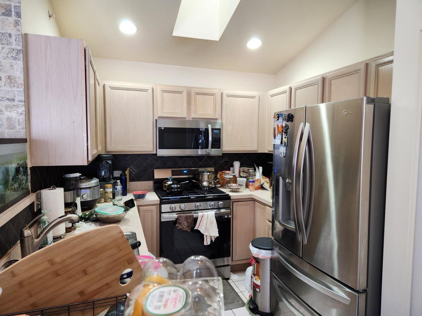 670 Mill Circle, Unit 305 Wheeling, IL 60090 - Photo 9 of 16 a kitchen with a sink appliances and cabinets