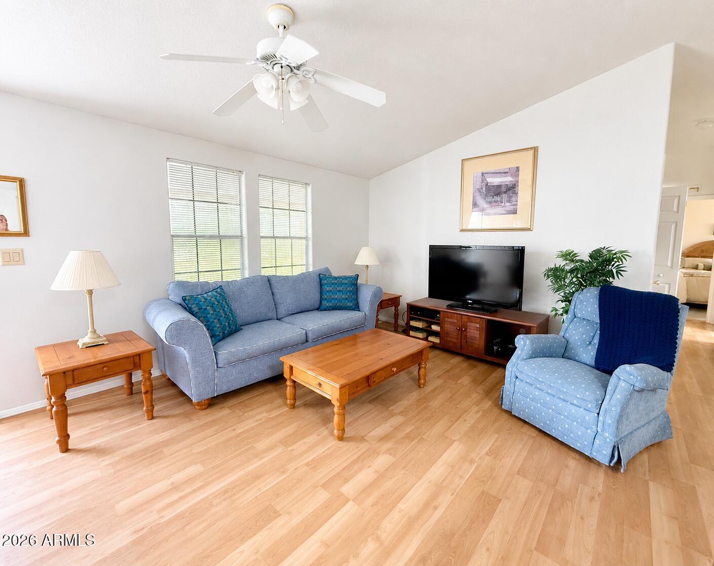8865 East Baseline Road, Unit 103 Mesa, AZ 85209 - Photo 7 of 47 a living room with furniture and a flat screen tv