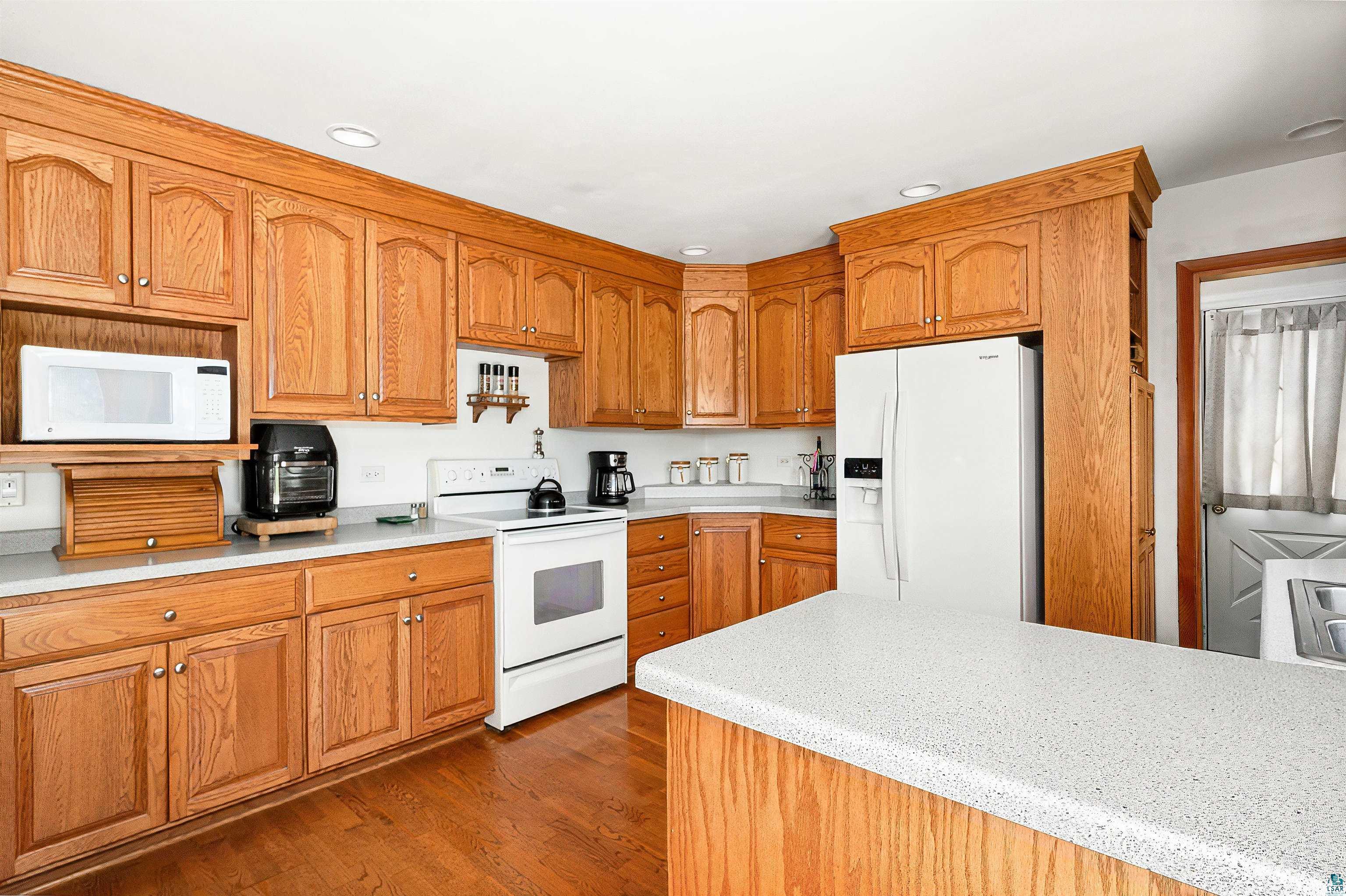 4387 Midway Road Hermantown, MN 55811 - Photo 6 of 35 Kitchen featuring dark hardwood / wood-style flooring and white appliances