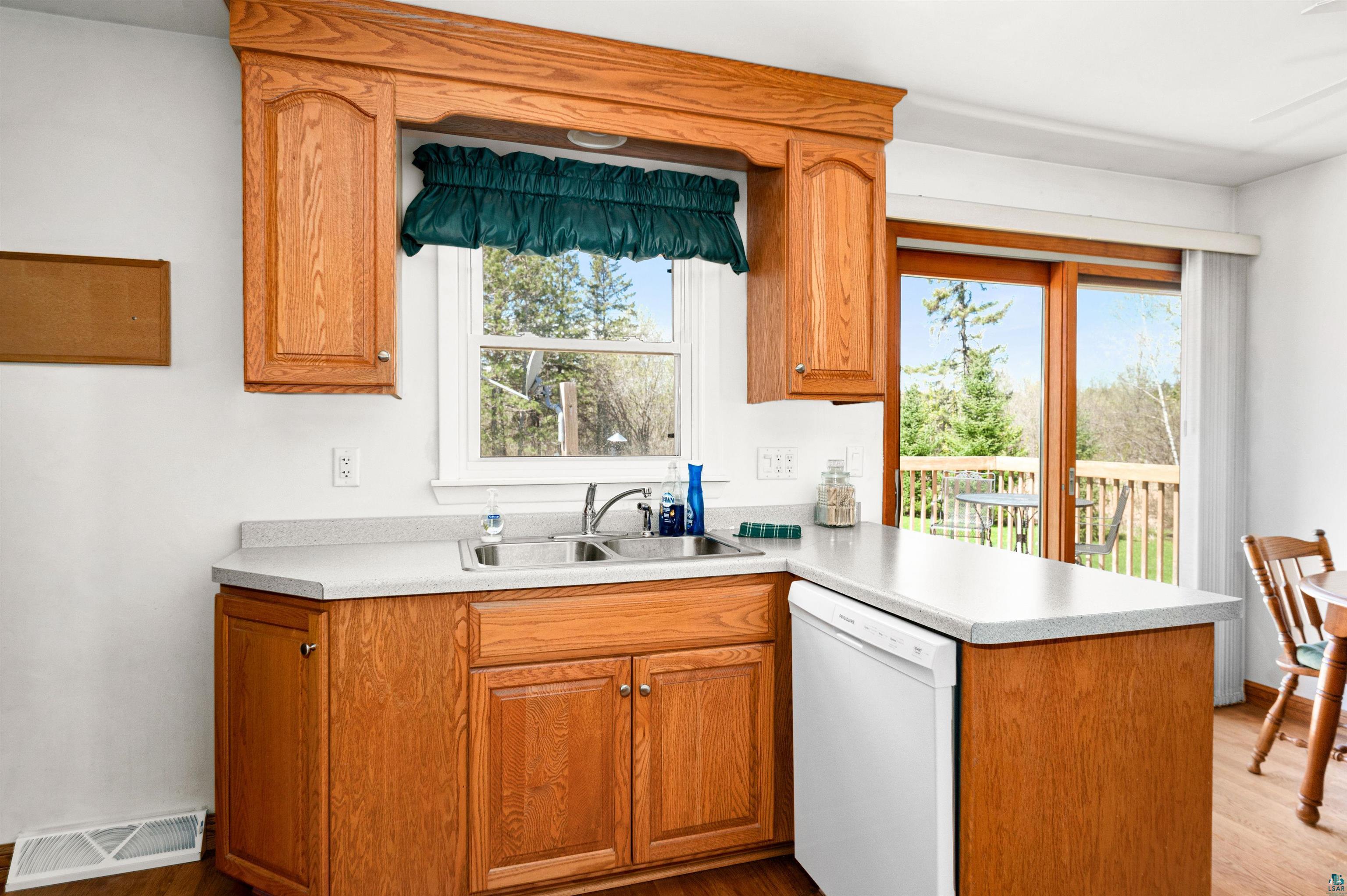 4387 Midway Road Hermantown, MN 55811 - Photo 7 of 35 Kitchen featuring light wood-type flooring, a healthy amount of sunlight, sink, and dishwasher