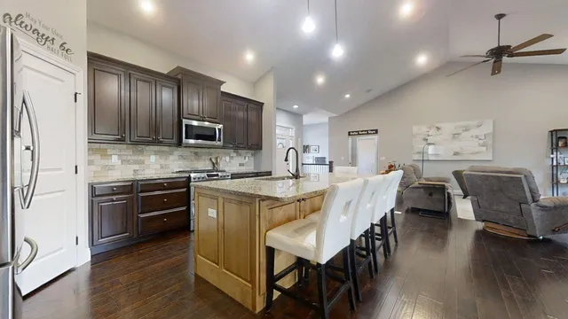 a kitchen with granite countertop stainless steel appliances and wooden cabinets