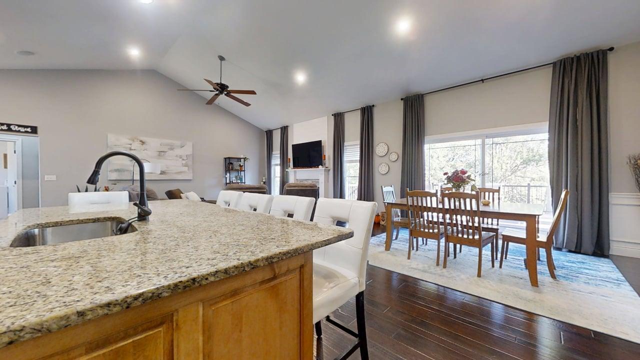 2112 Slade Lane Mahomet, IL 61853 - Photo 16 of 68 a kitchen with granite countertop a table chairs stove and wooden floor