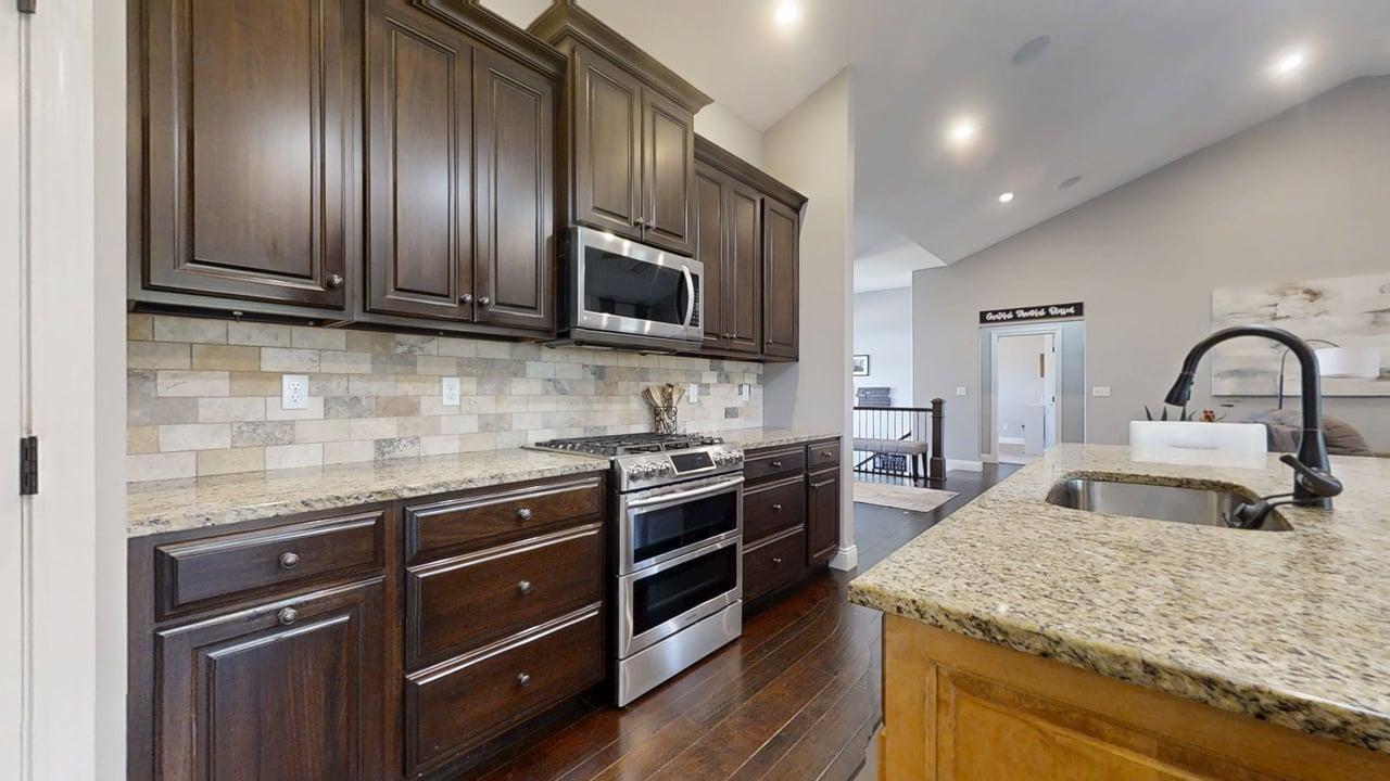 2112 Slade Lane Mahomet, IL 61853 - Photo 17 of 68 a kitchen with granite countertop stainless steel appliances and wooden cabinets