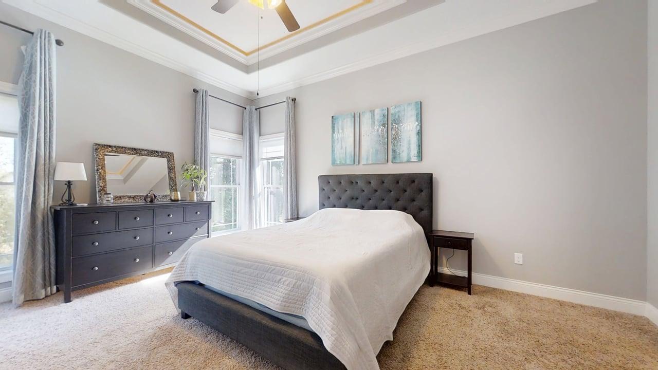 2112 Slade Lane Mahomet, IL 61853 - Photo 19 of 68 a bedroom with a large bed and a dresser