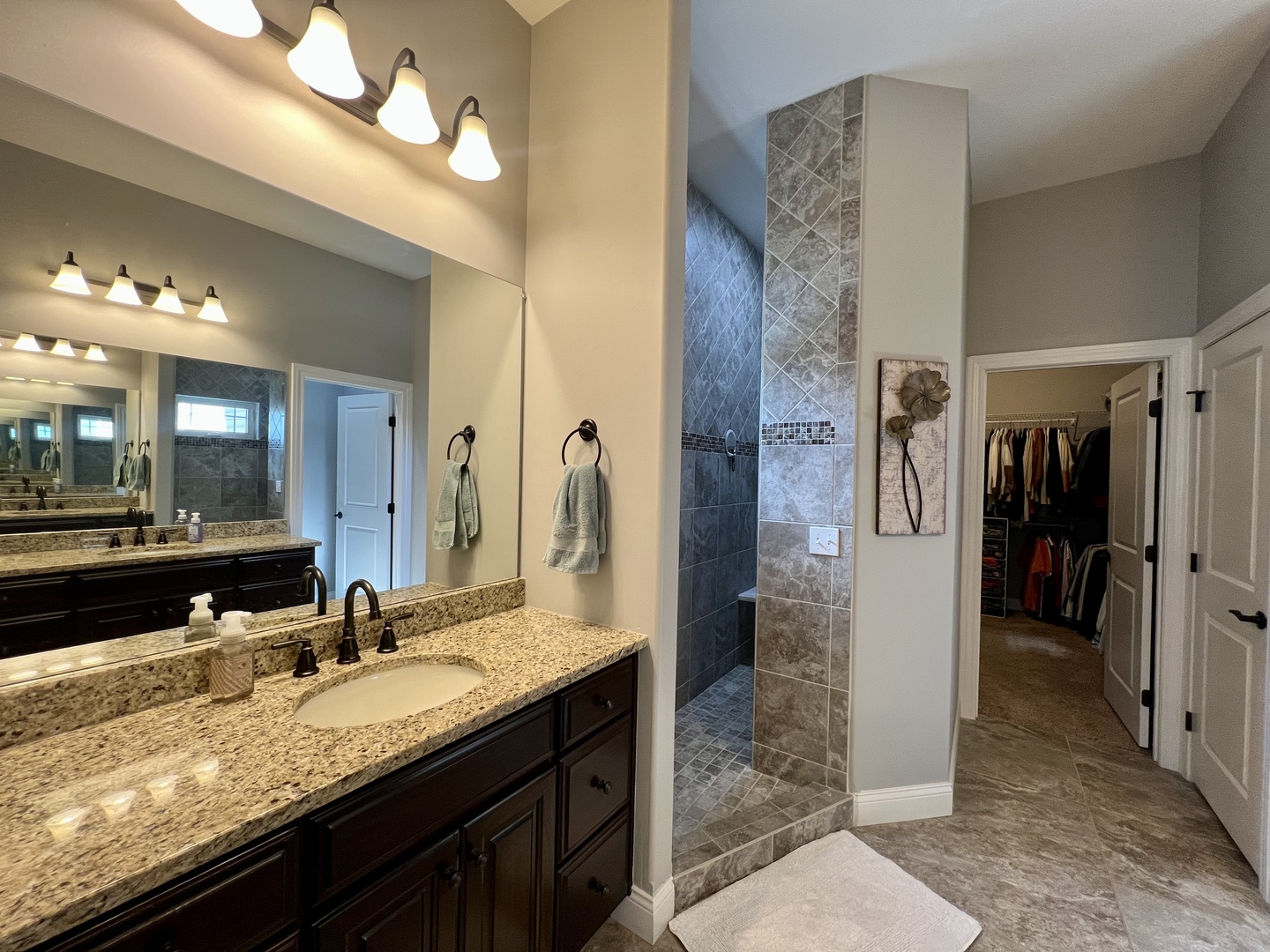 2112 Slade Lane Mahomet, IL 61853 - Photo 23 of 68 a bathroom with a granite countertop sink a large mirror and a shower
