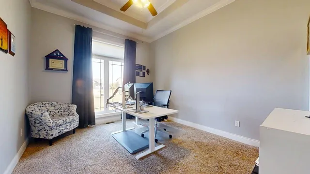 a living room with furniture a wooden floor and a kitchen