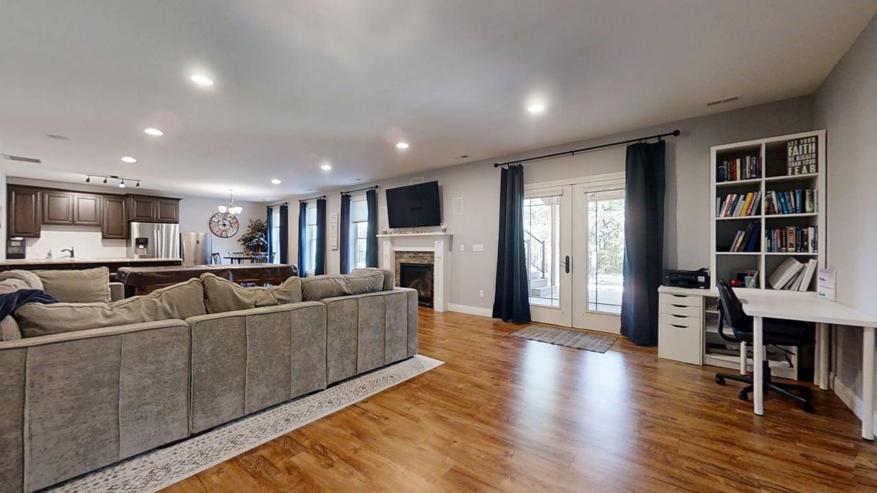 2112 Slade Lane Mahomet, IL 61853 - Photo 45 of 68 a living room with furniture a wooden floor and a kitchen