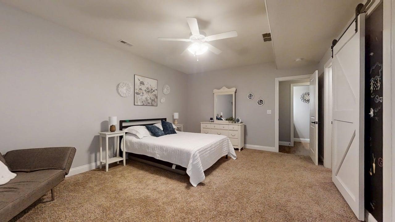 2112 Slade Lane Mahomet, IL 61853 - Photo 50 of 68 a spacious bedroom with a bed and a couch