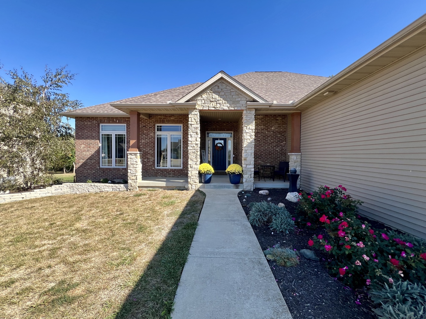 2112 Slade Lane Mahomet, IL 61853 - Photo 5 of 68 a view of a house with large windows and potted plants