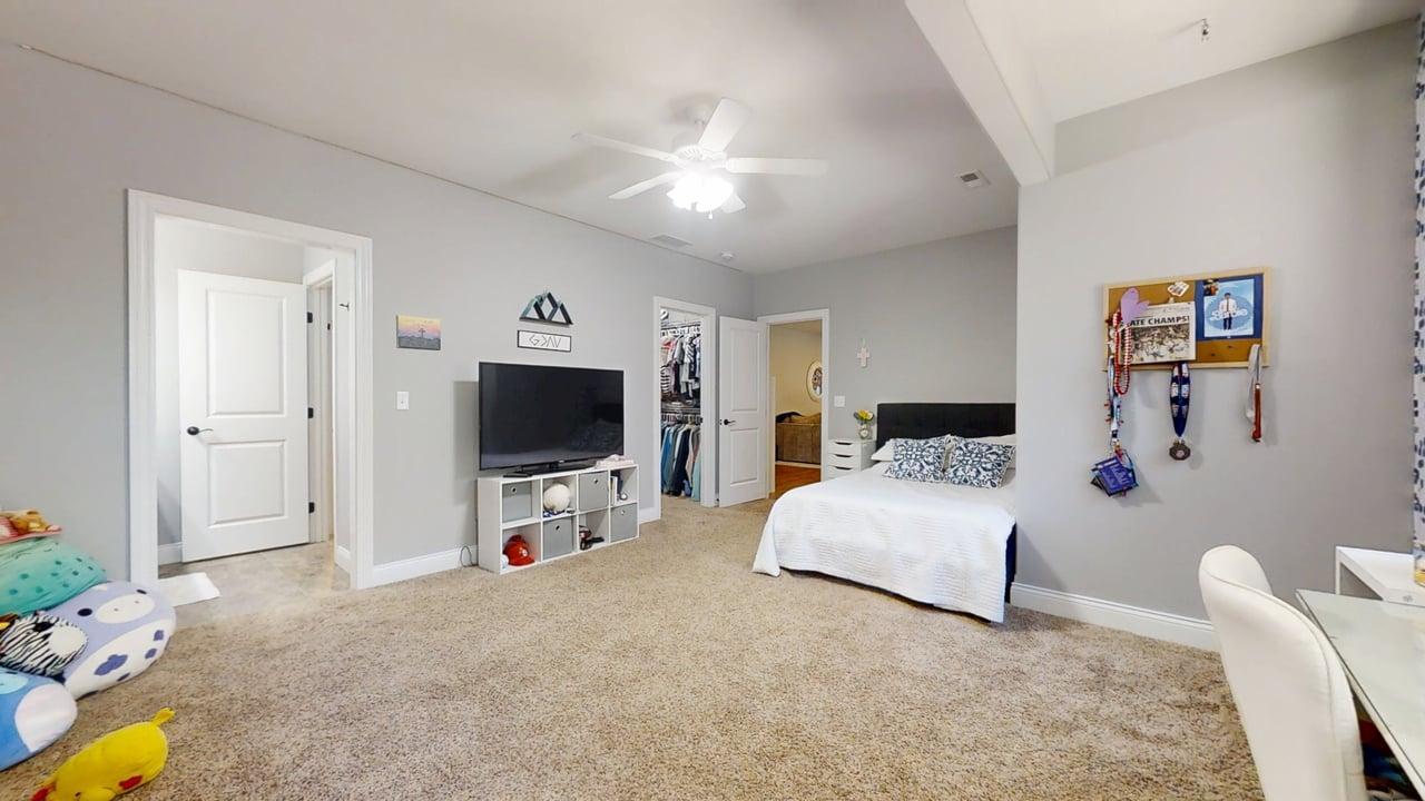 2112 Slade Lane Mahomet, IL 61853 - Photo 54 of 68 a bedroom with a bed and a flat tv screen on dresser