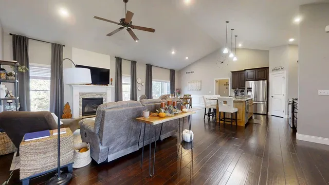 a living room with fireplace furniture and a wooden floor