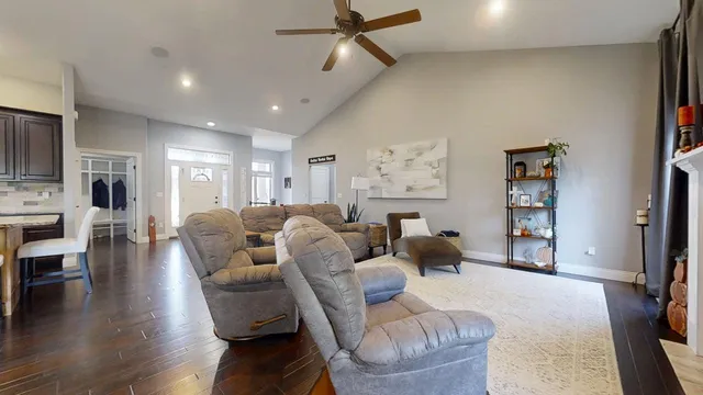 a living room with furniture a wooden floor and a flat screen tv