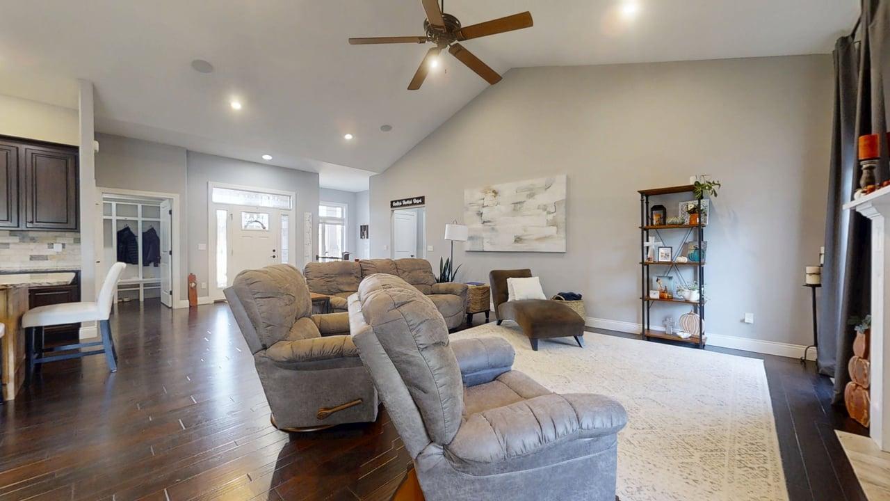 2112 Slade Lane Mahomet, IL 61853 - Photo 9 of 68 a living room with furniture a wooden floor and a flat screen tv