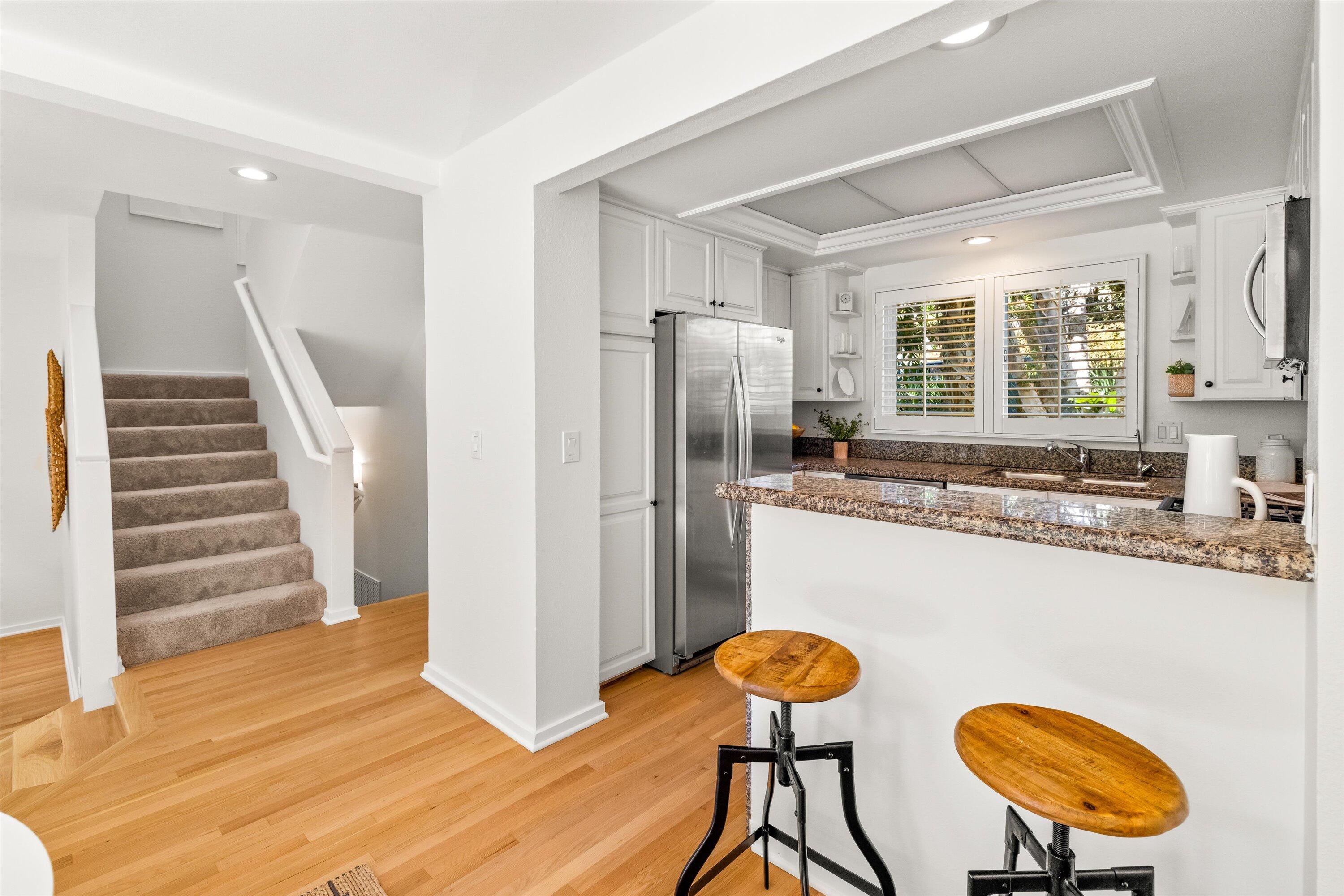 931 Weldon Road Santa Barbara, CA 93109 - Photo 6 of 32 a kitchen with stainless steel appliances refrigerator and wooden floor