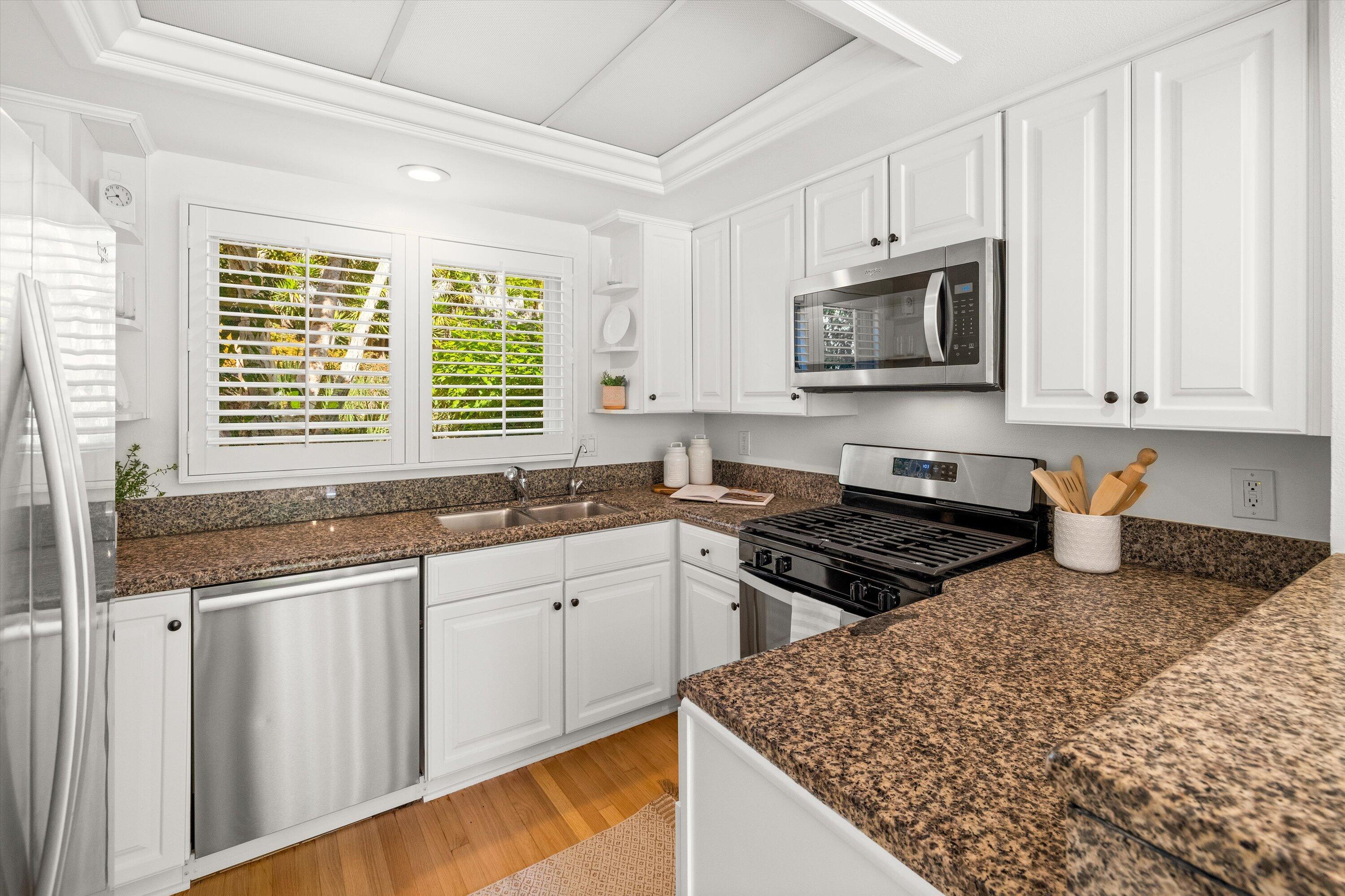 931 Weldon Road Santa Barbara, CA 93109 - Photo 7 of 32 a kitchen with stainless steel appliances granite countertop a sink stove and microwave