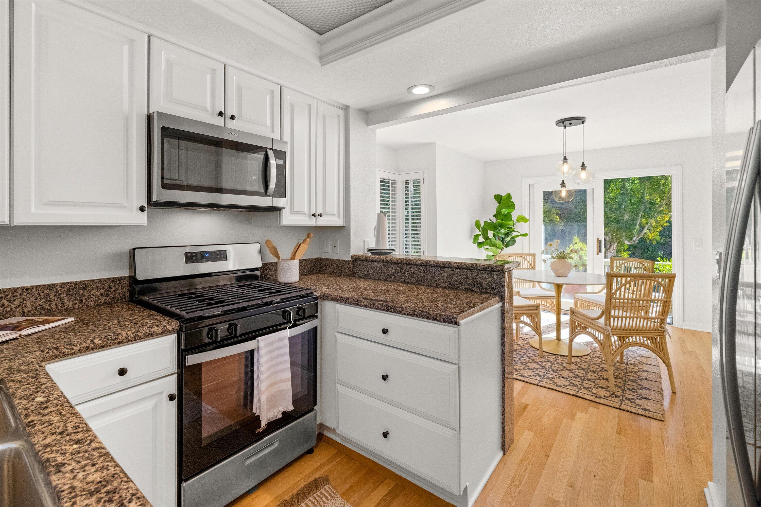 931 Weldon Road Santa Barbara, CA 93109 - Photo 8 of 32 a kitchen with stainless steel appliances granite countertop a stove a sink and a microwave