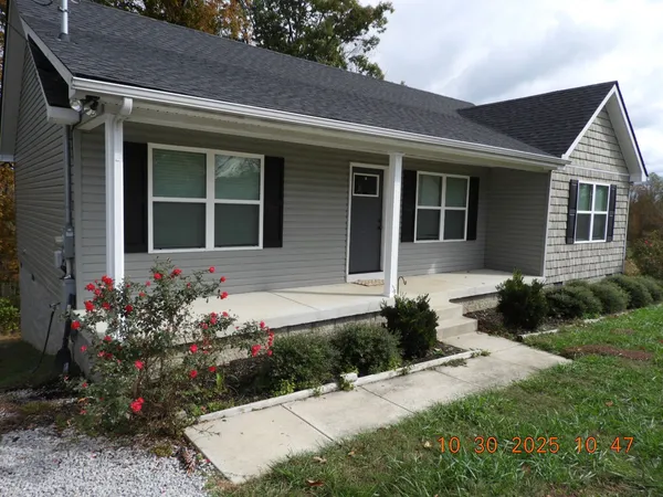 a front view of a house with a yard