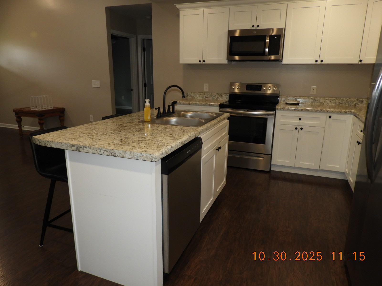 155 Poling Drive Pulaski, TN 38478 - Photo 19 of 36 a kitchen with stainless steel appliances granite countertop a sink stove and microwave