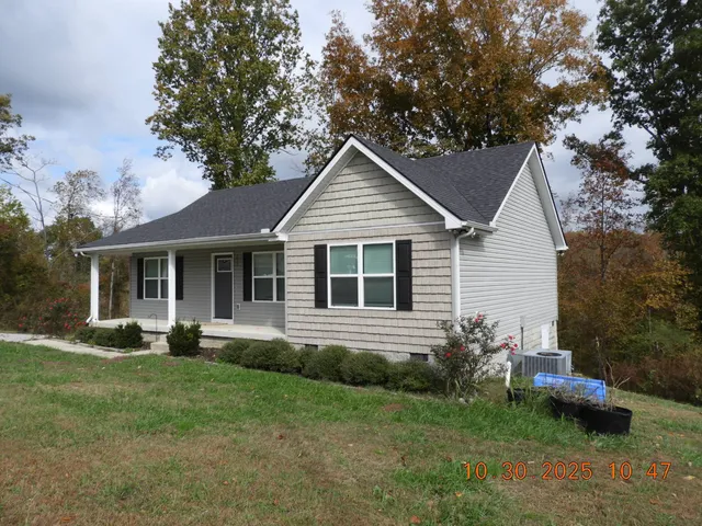 a view of a house with a yard and plants