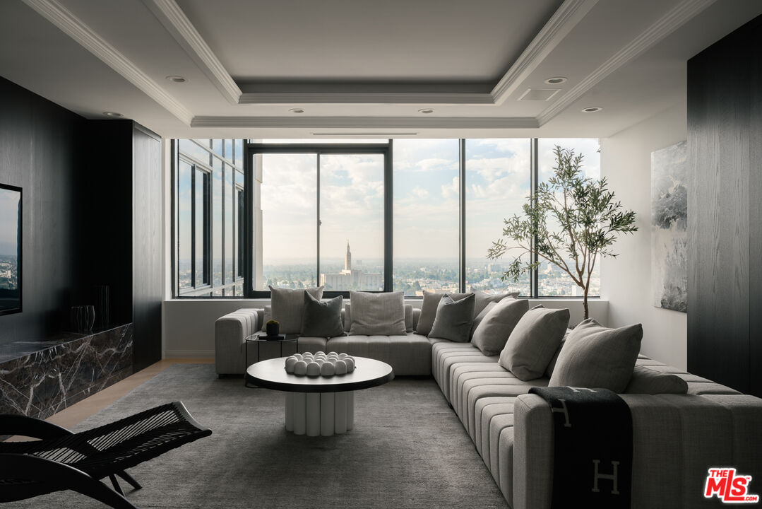 10724 Wilshire Boulevard, Unit 1501 Los Angeles, CA 90024 - Photo 13 of 38 a living room with furniture and a flat screen tv