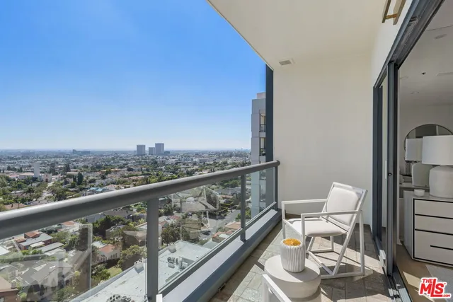 a view of a balcony with chair and wooden floor
