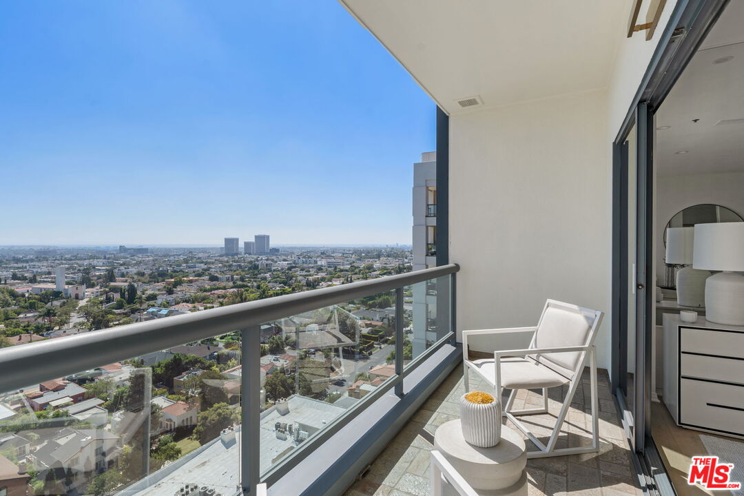 10724 Wilshire Boulevard, Unit 1501 Los Angeles, CA 90024 - Photo 18 of 38 a view of a balcony with chair and wooden floor