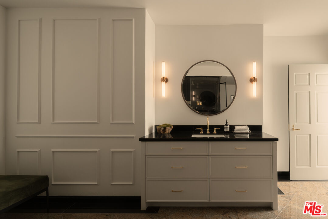10724 Wilshire Boulevard, Unit 1501 Los Angeles, CA 90024 - Photo 21 of 38 a bathroom with a sink and a mirror