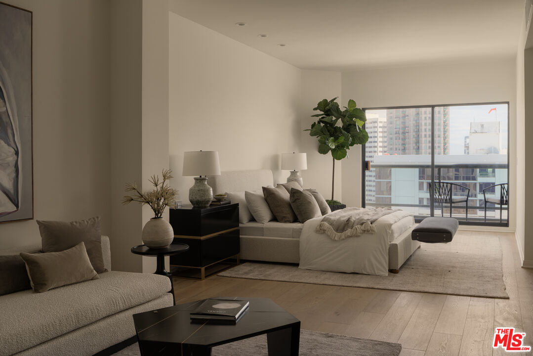 10724 Wilshire Boulevard, Unit 1501 Los Angeles, CA 90024 - Photo 24 of 38 a living room with furniture and a large window