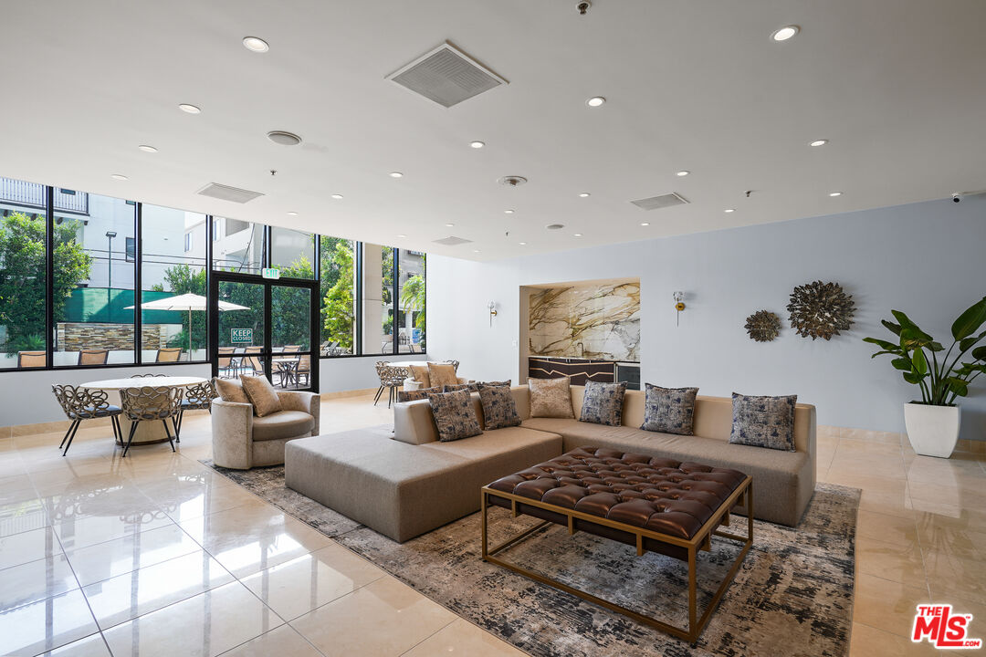 10724 Wilshire Boulevard, Unit 1501 Los Angeles, CA 90024 - Photo 32 of 38 a living room with furniture potted plant and a large window