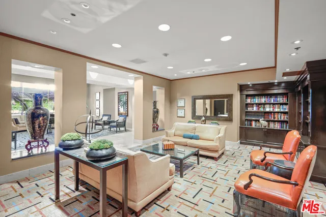 a living room with furniture a rug and a book shelf