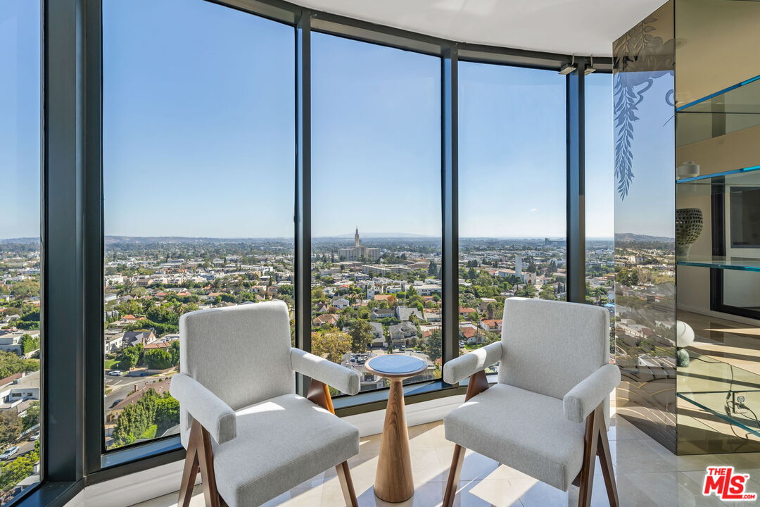 10724 Wilshire Boulevard, Unit 1501 Los Angeles, CA 90024 - Photo 6 of 38 a view of a city from a dining room with a table or chairs