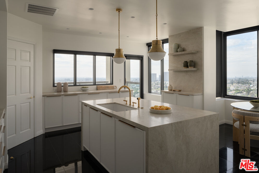 10724 Wilshire Boulevard, Unit 1501 Los Angeles, CA 90024 - Photo 9 of 38 a kitchen with sink cabinets and window