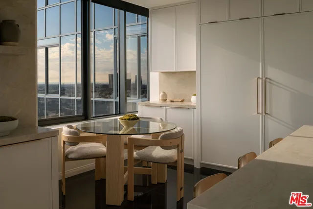 a dining room with furniture and a window