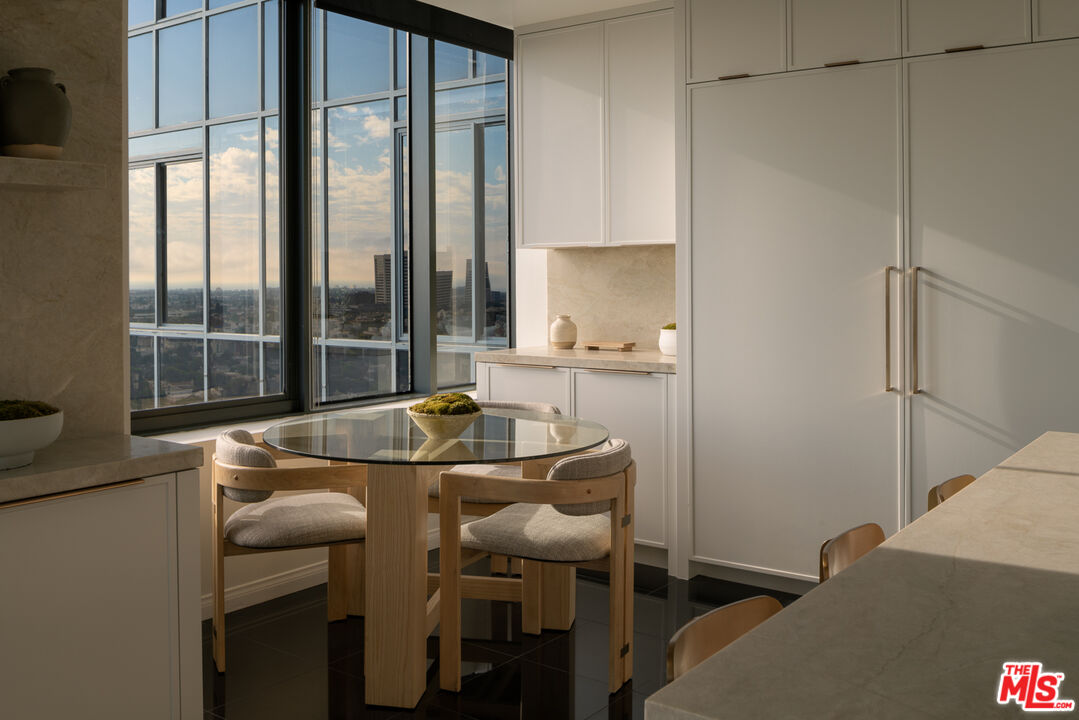 10724 Wilshire Boulevard, Unit 1501 Los Angeles, CA 90024 - Photo 10 of 38 a dining room with furniture and a window