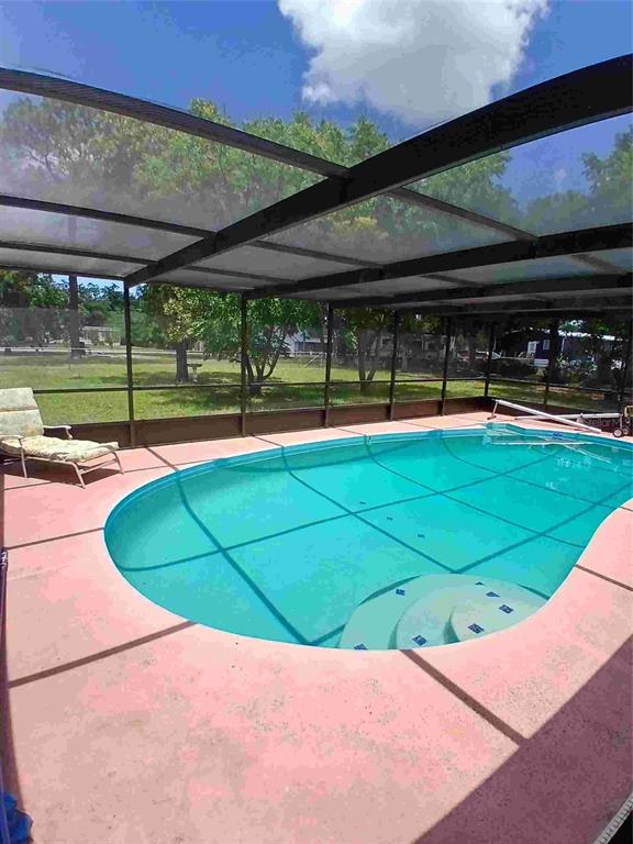 9739 Ray Street Hudson, FL 34669 - Photo 8 of 36 a view of a swimming pool with a yard