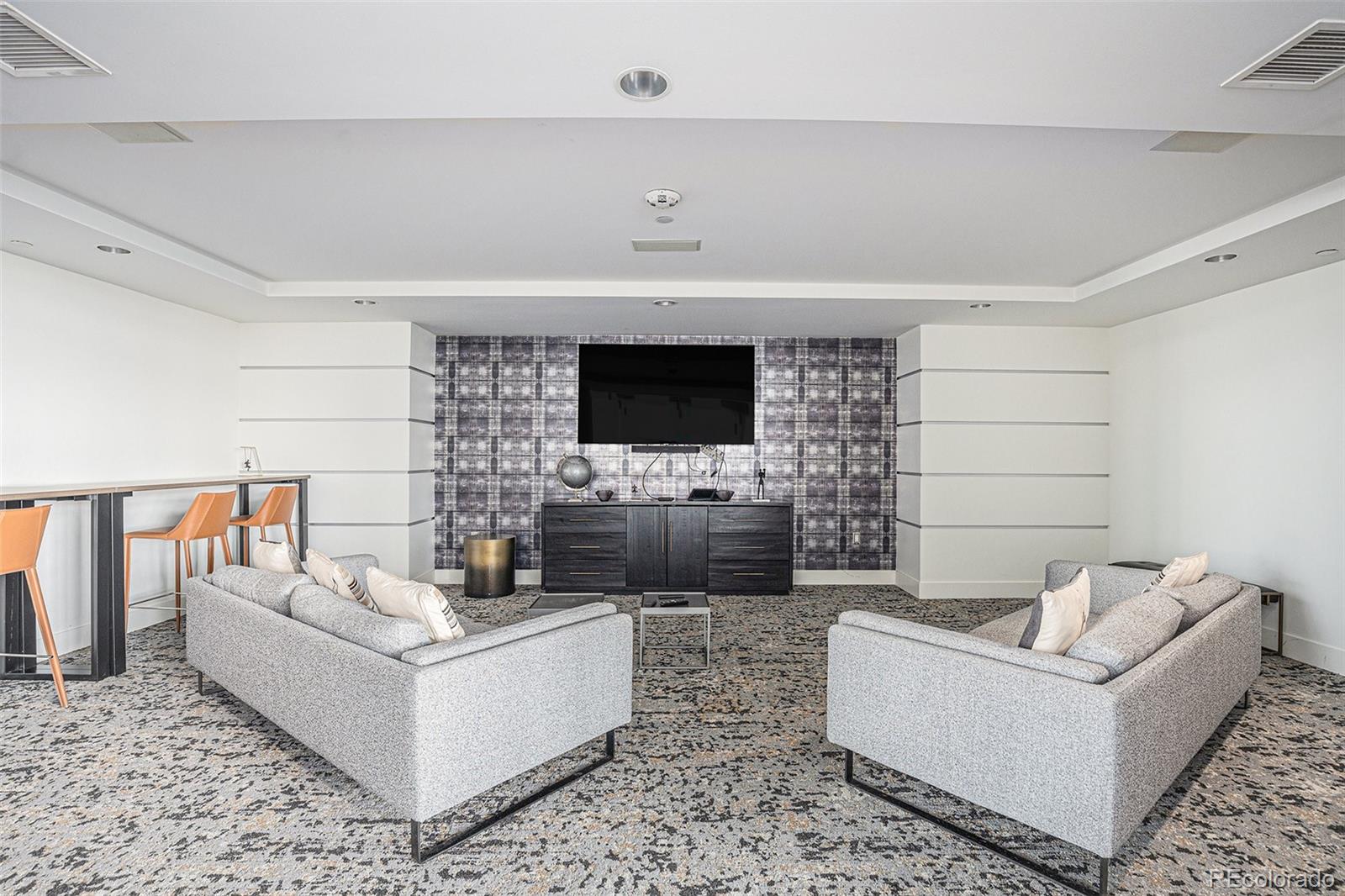 1700 Bassett Street, Unit 903 Denver, CO 80202 - Photo 23 of 31 a living room with furniture and a flat screen tv