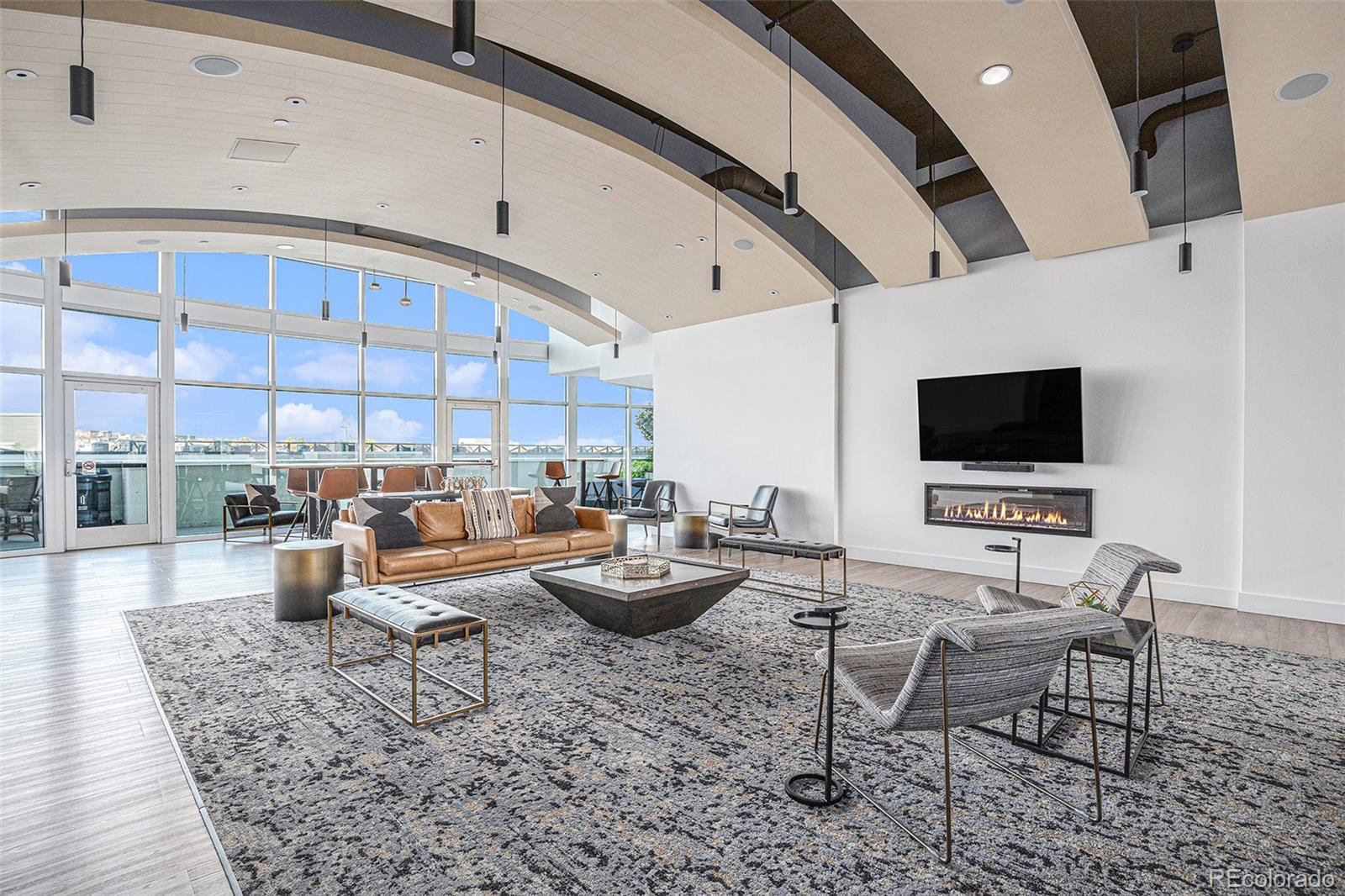 1700 Bassett Street, Unit 903 Denver, CO 80202 - Photo 24 of 31 a living room with furniture and a flat screen tv