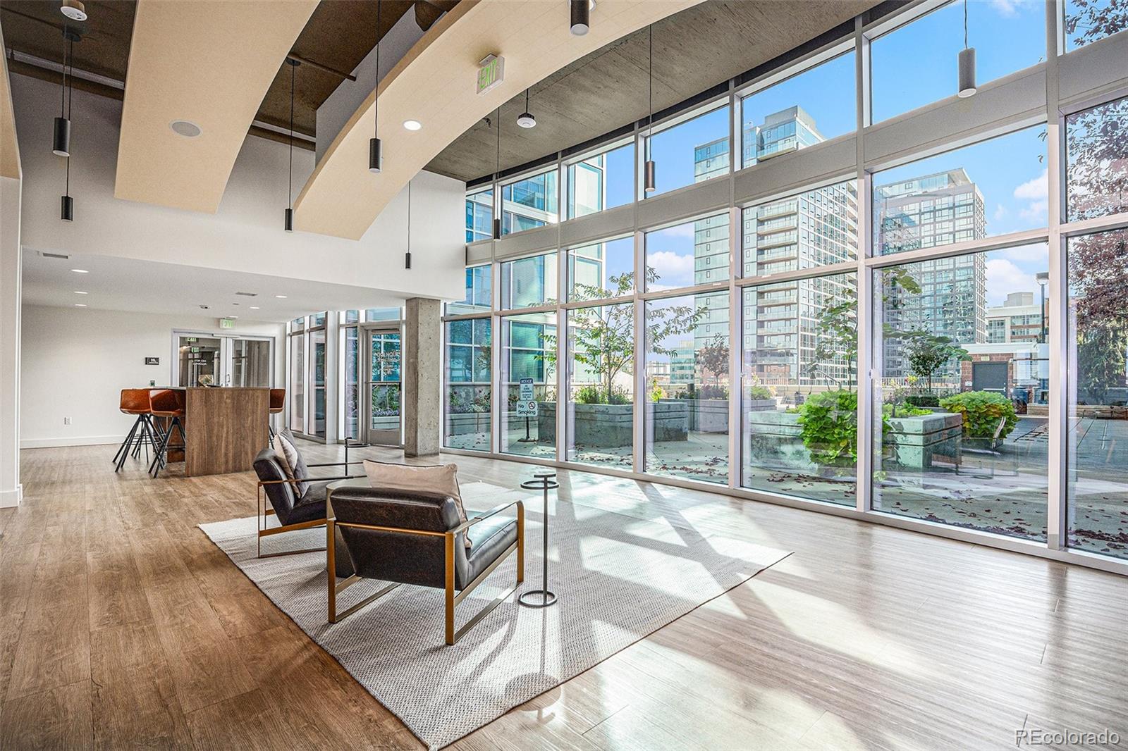 1700 Bassett Street, Unit 903 Denver, CO 80202 - Photo 25 of 31 a living room with furniture floor to ceiling window and wooden floor
