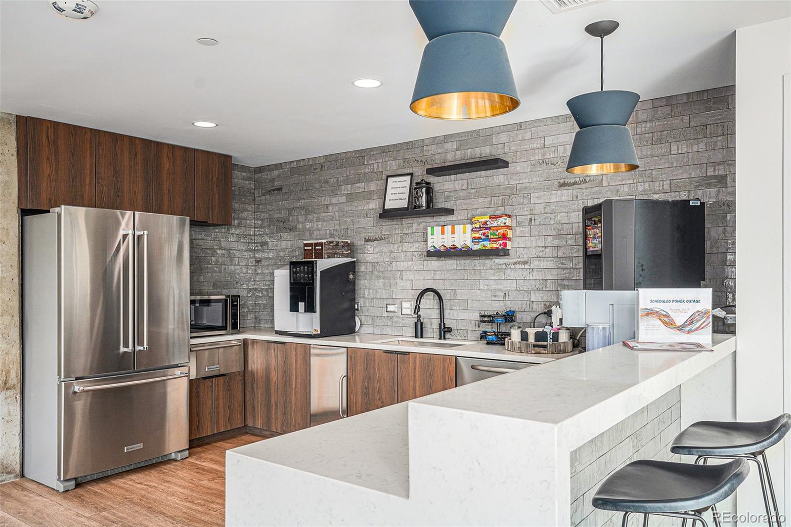 1700 Bassett Street, Unit 903 Denver, CO 80202 - Photo 26 of 31 a kitchen with stainless steel appliances a sink a stove a refrigerator and cabinets