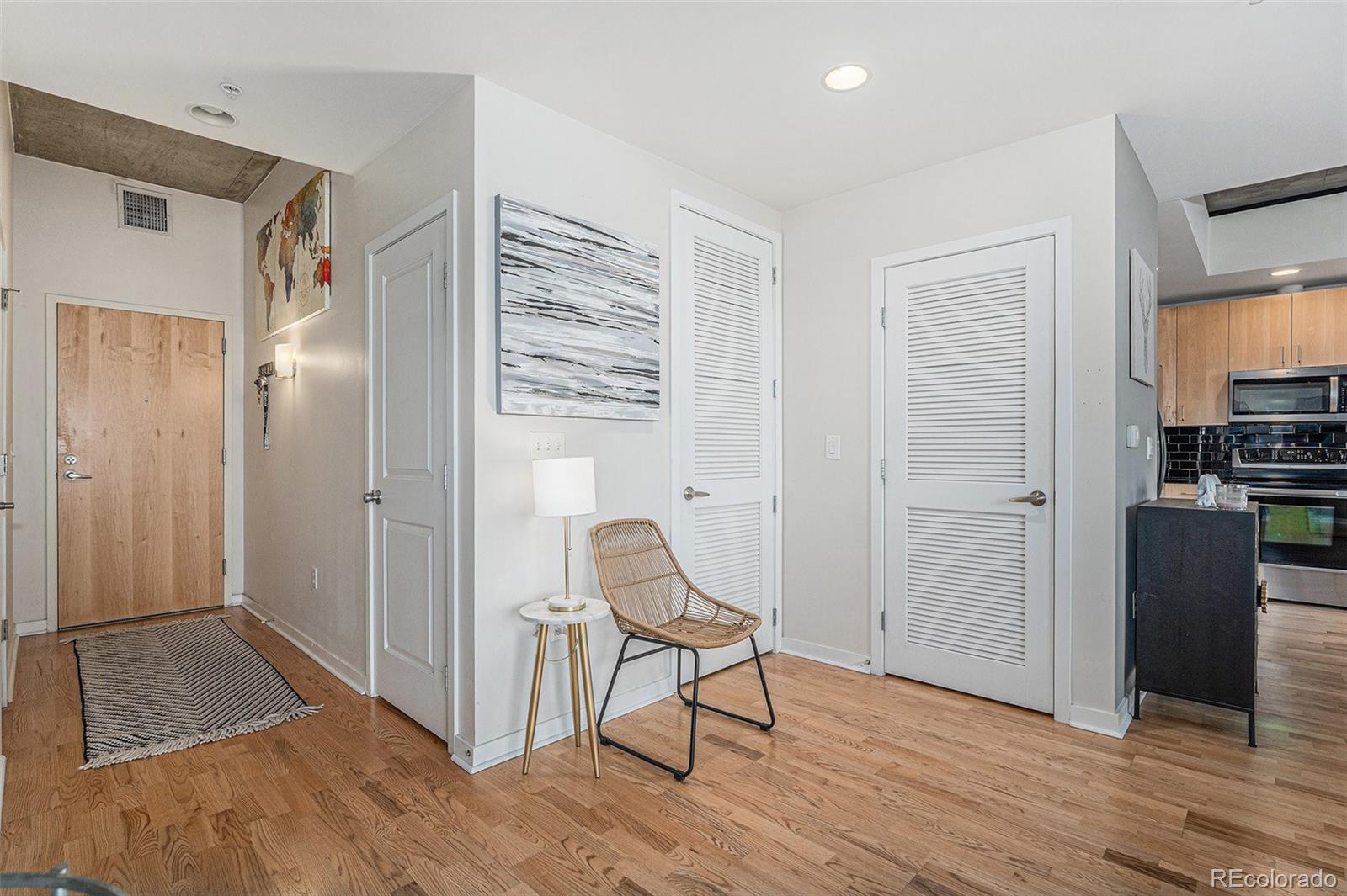 1700 Bassett Street, Unit 903 Denver, CO 80202 - Photo 6 of 31 a view of a room with wooden floor and furniture