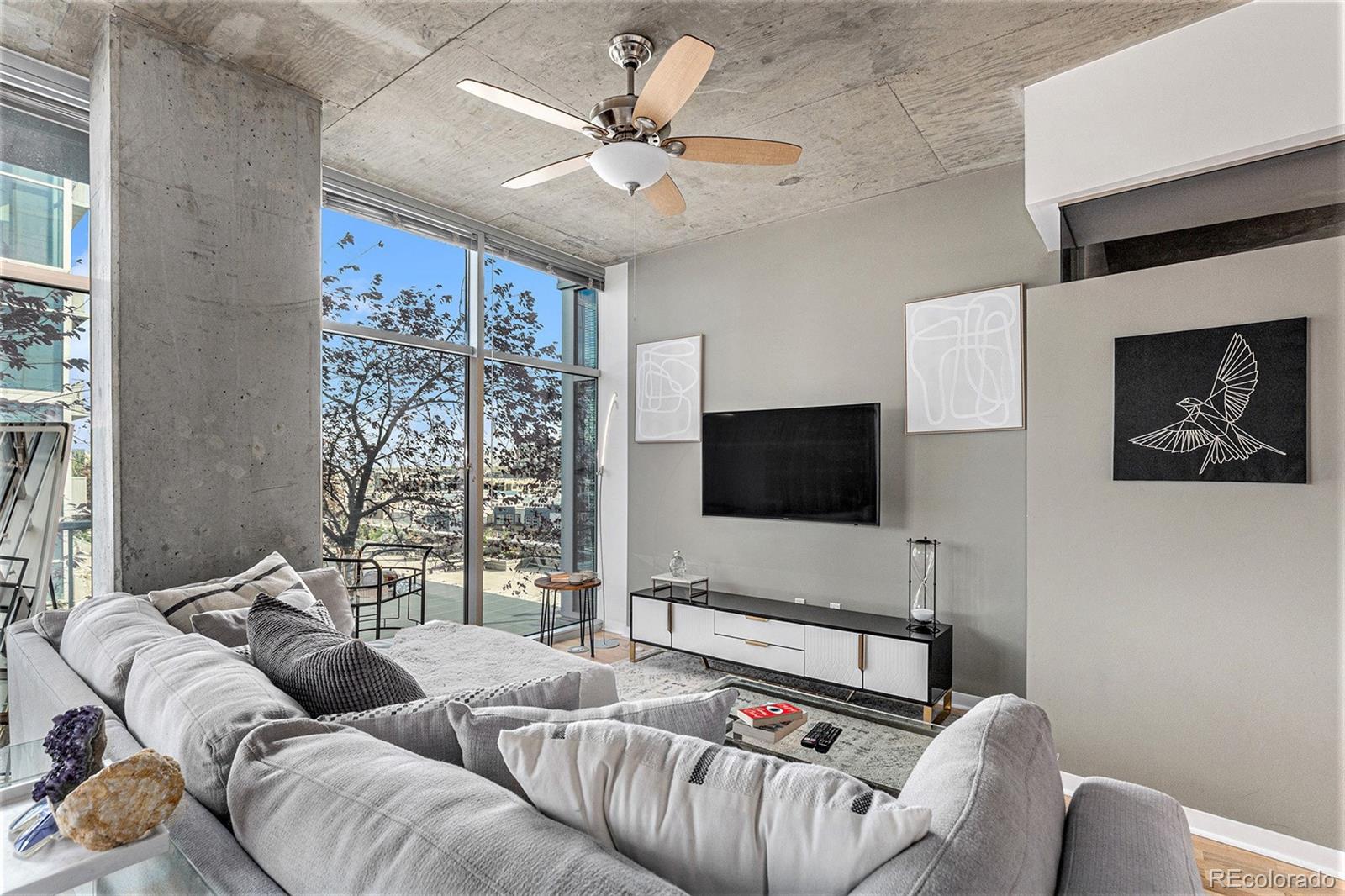 1700 Bassett Street, Unit 903 Denver, CO 80202 - Photo 8 of 31 a living room with furniture and a flat screen tv