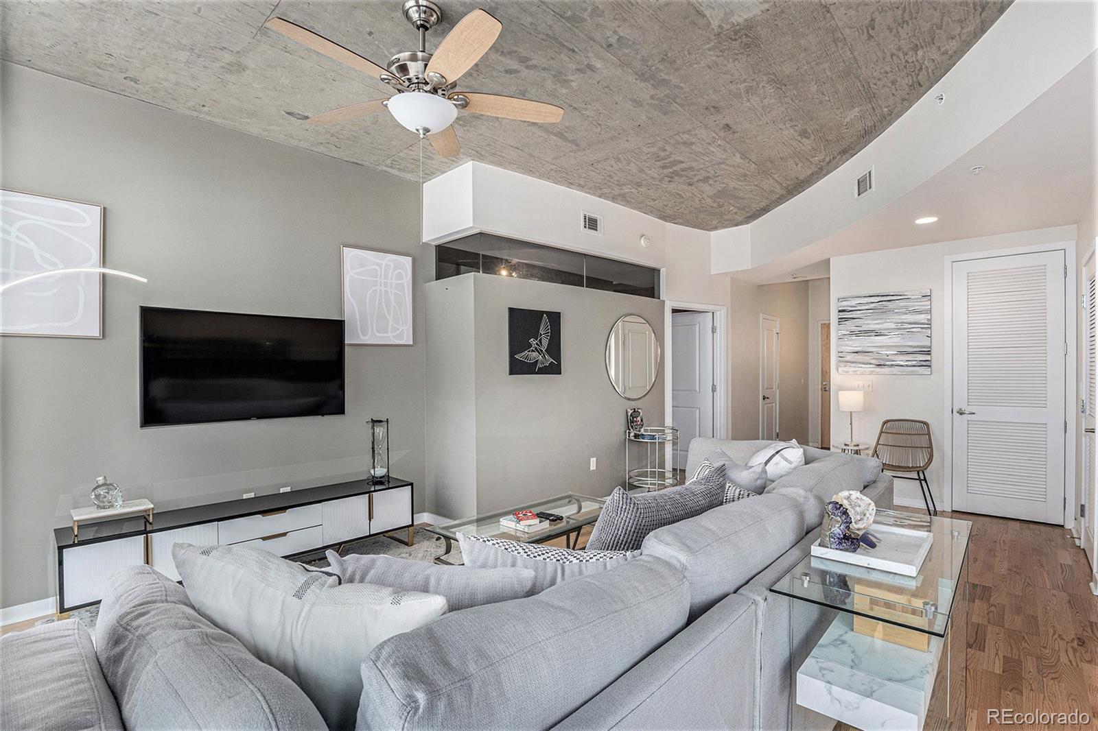 1700 Bassett Street, Unit 903 Denver, CO 80202 - Photo 9 of 31 a living room with furniture and a flat screen tv