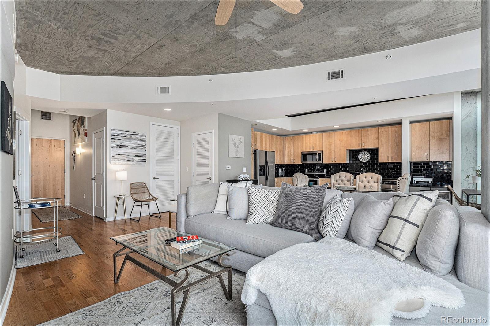 1700 Bassett Street, Unit 903 Denver, CO 80202 - Photo 10 of 31 a living room with furniture kitchen view and a large window